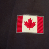 Canadian flag patch on black 3 button polo sleeve