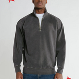 A person wearing a grey zip polo sweatshirt, standing against a plain background with a small red maple leaf logo in the corner, indicating that the garment was made in Canada.