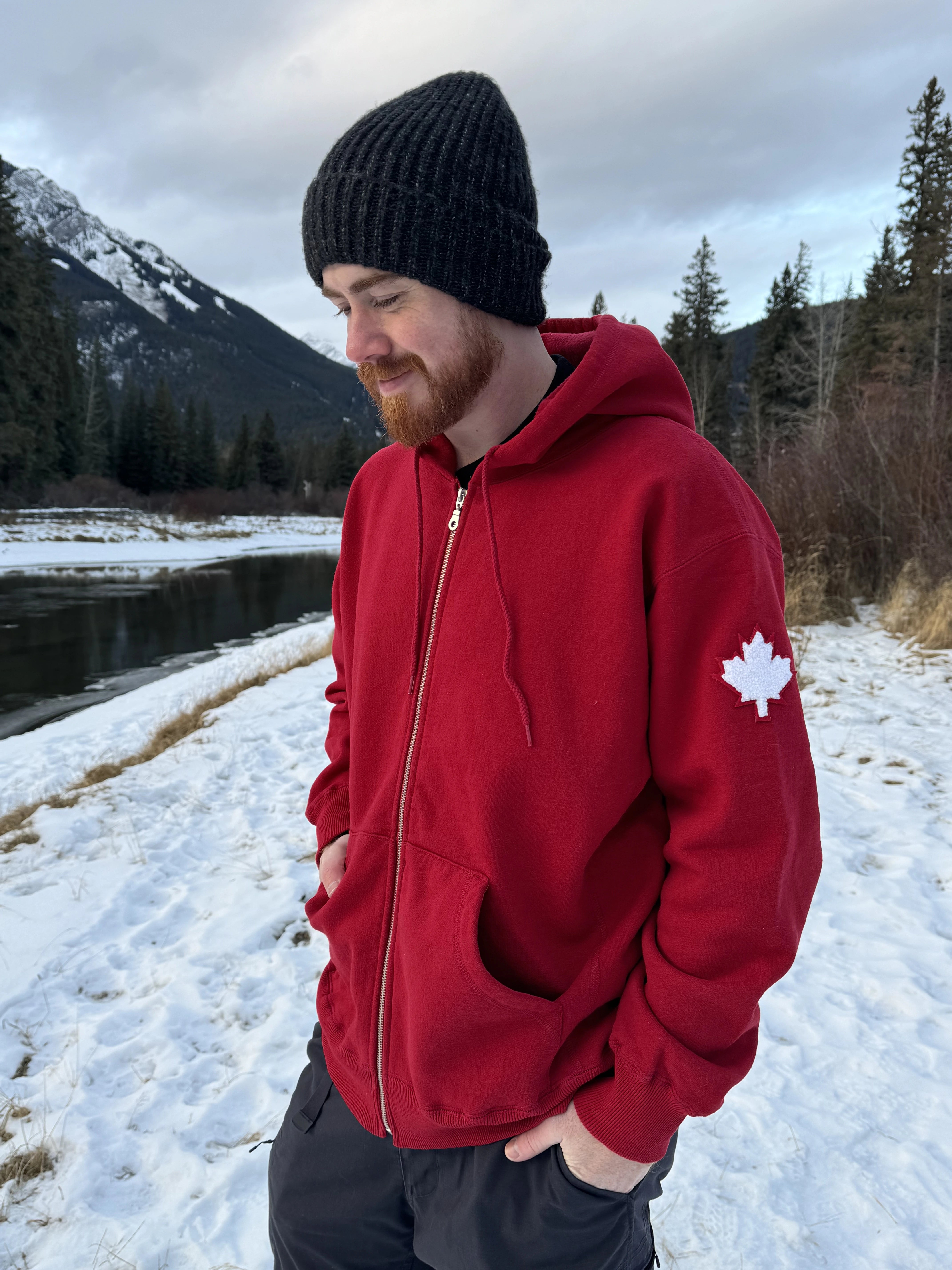 Full Zip red Hoodie with white canada maple leaf logo on left arm.