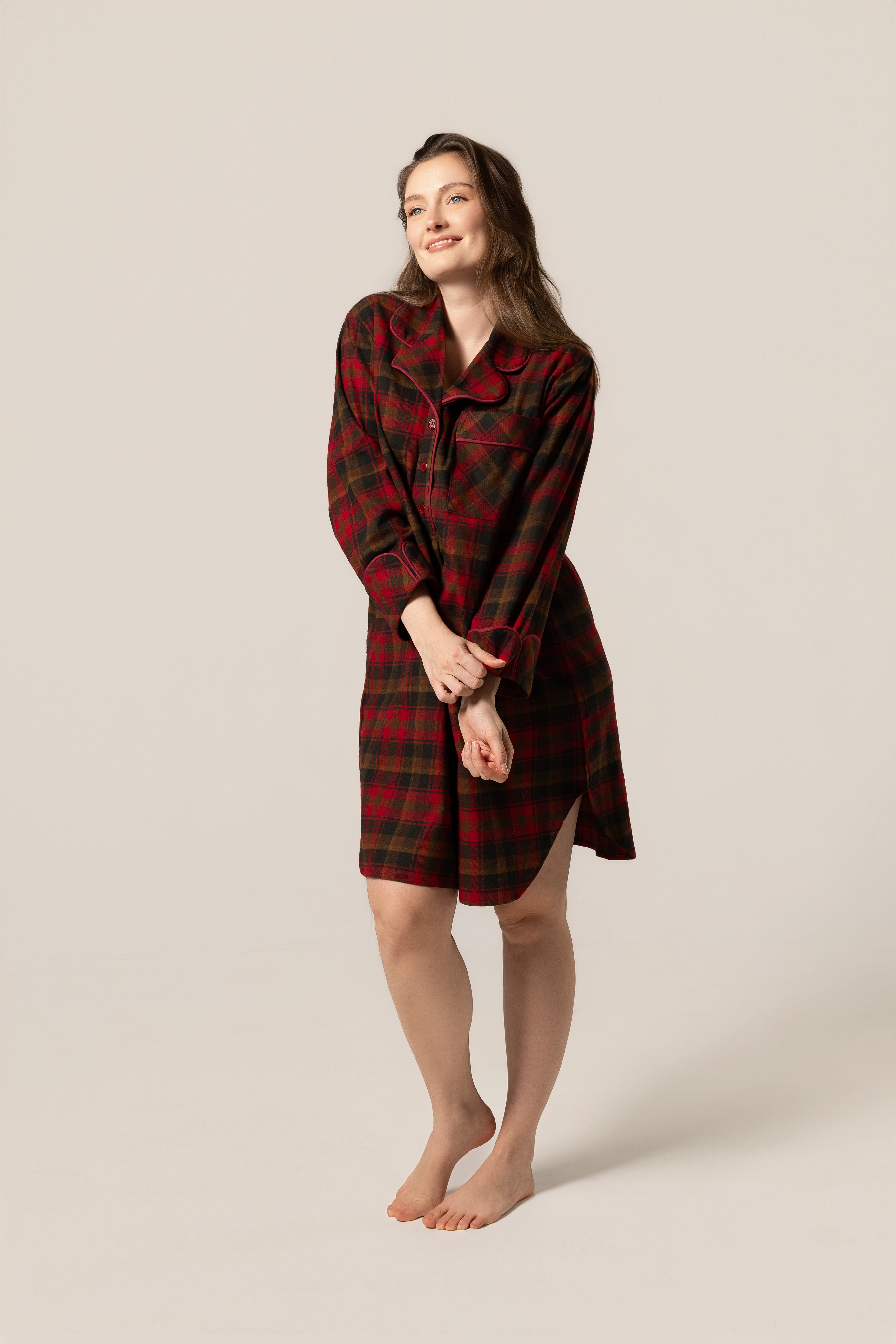 Woman wearing amaple leaf tartan nightshir against a beige background