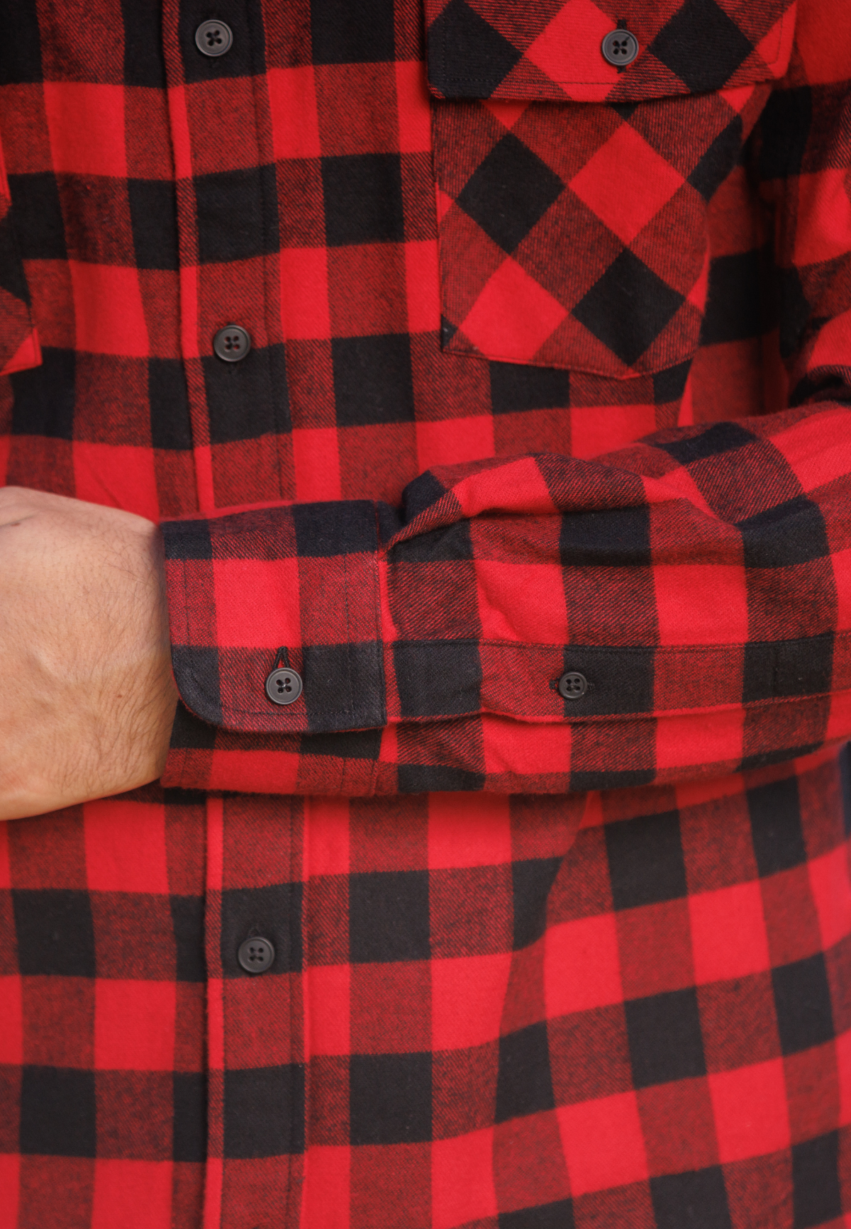 Close-up of a red and black checkered shirt with a focus on the pattern and fabric texture.