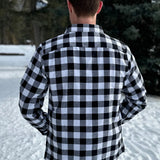 Back view of Classic Black and White Buffalo Check Shirt taken outside in the snow in Banff, Canada. The shirt has 2 front pockets and is fitted.