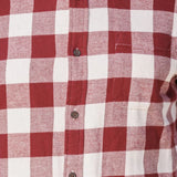 Close up of a burgundy and white buffalo check flannel shirt.