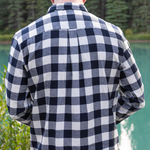 Back view of a man wearing a navy and cream check flannel shirt with a button-down collar, single breast pocket, and long sleeves.