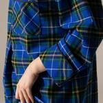 Nova scotia tartan nightshirt with a hand adjusting the collar against a neutral background