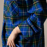 Nova scotia tartan nightshirt with a hand adjusting the collar against a neutral background