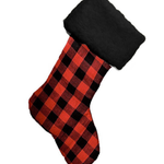 Red and black plaid Christmas stocking on a white background