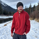 Red quarter zip polo with canada flag logo on left arm.