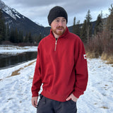 Red quarter zip polo with canada flag logo on left arm.