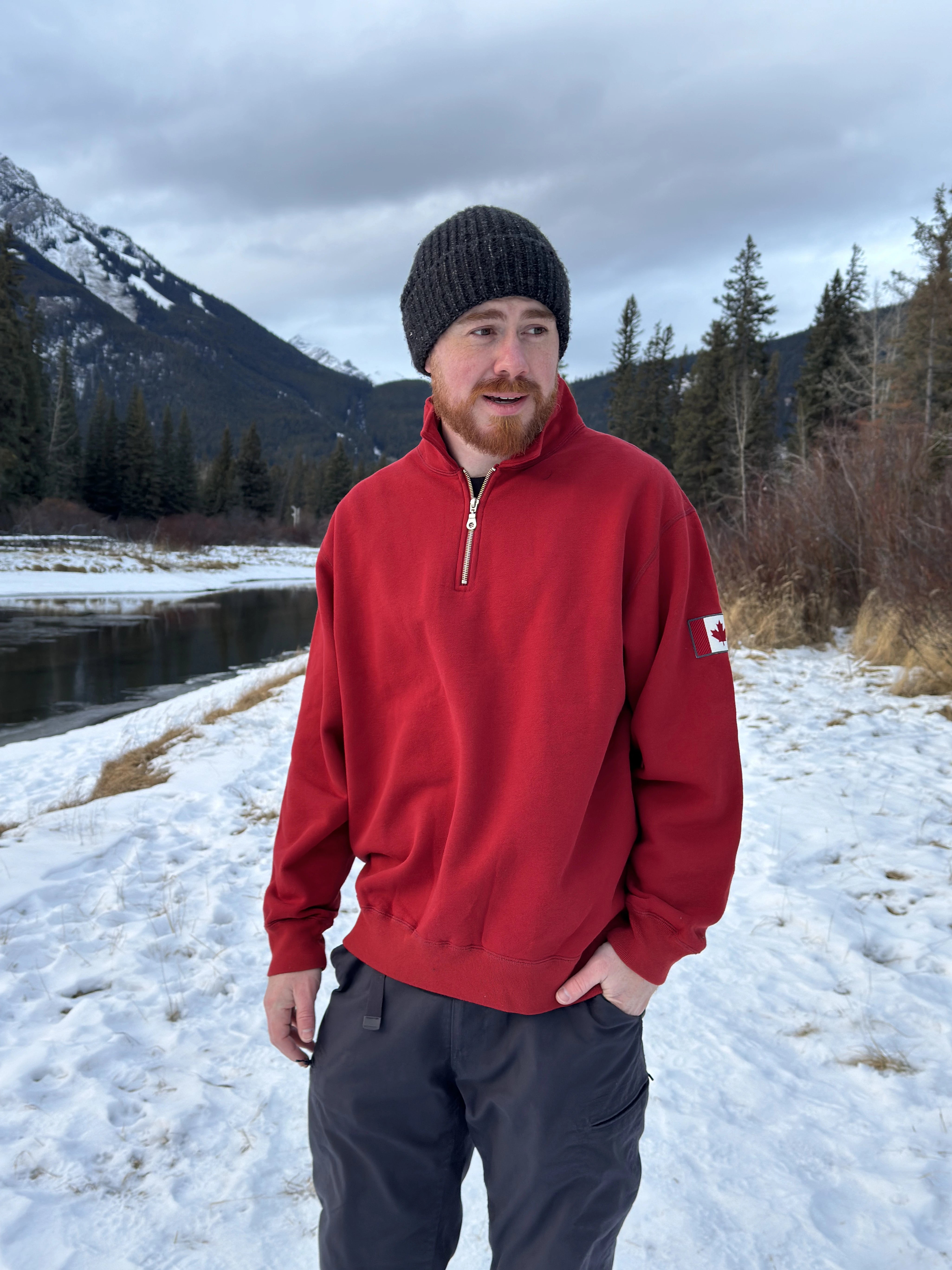 Red quarter zip polo with canada flag logo on left arm.