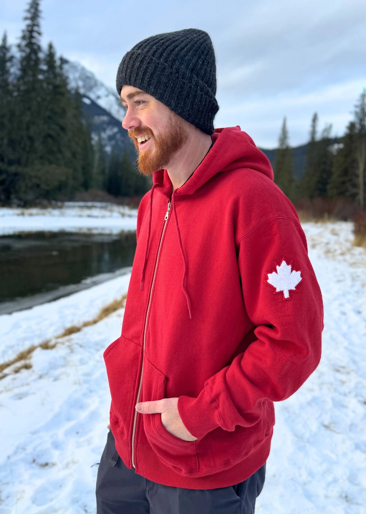 Full Zip red Hoodie with white canada maple leaf logo on left arm.