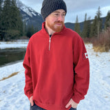 Red quarter zip polo with canada flag logo on left arm.
