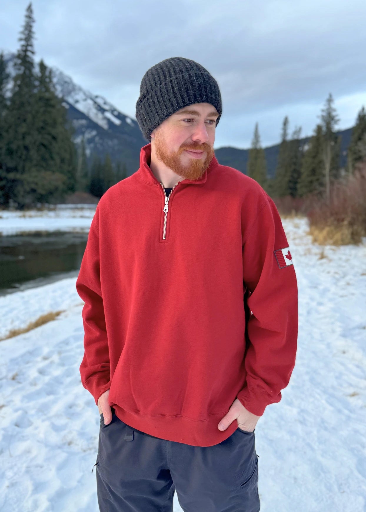 Red quarter zip polo with canada flag logo on left arm.