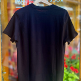 Black t-shirt on a hanger with a blurred store and floral background