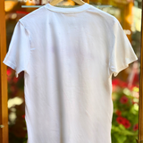 White t-shirt on a hanger with a blurred background