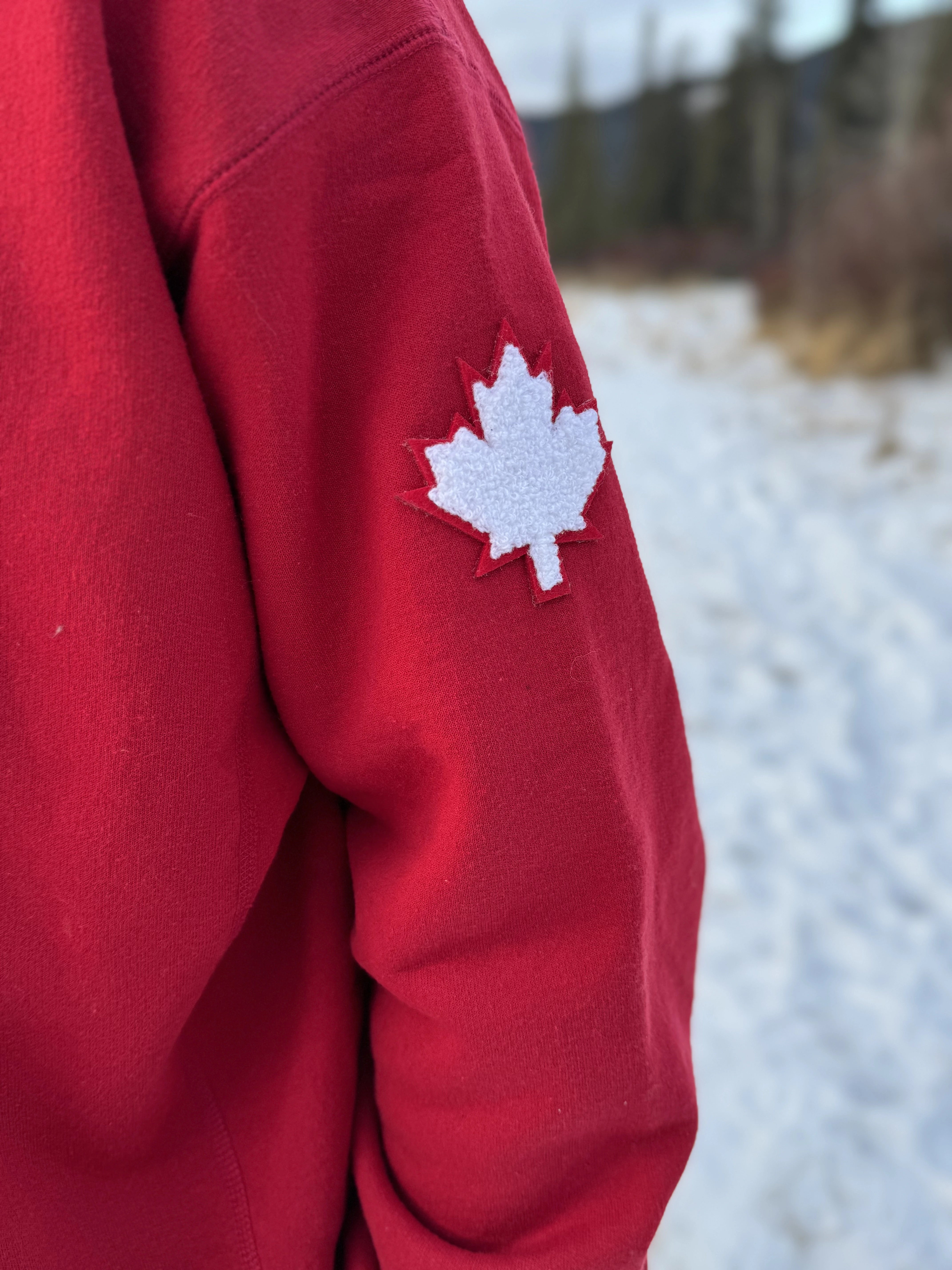 Close up of white canada maple leaf logo on left arm.