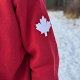 Close up of white canada maple leaf logo on left arm.