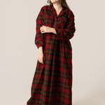 Woman wearing a maple leaf tartan nightshirt against a beige background