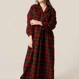 Woman wearing a maple leaf tartan nightshirt against a beige background