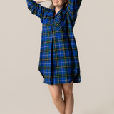 Woman wearing a nova scotia tartan nightshirt against a beige background