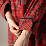 Red plaid nightgown with a close-up of hands adjusting the cuff against a neutral background