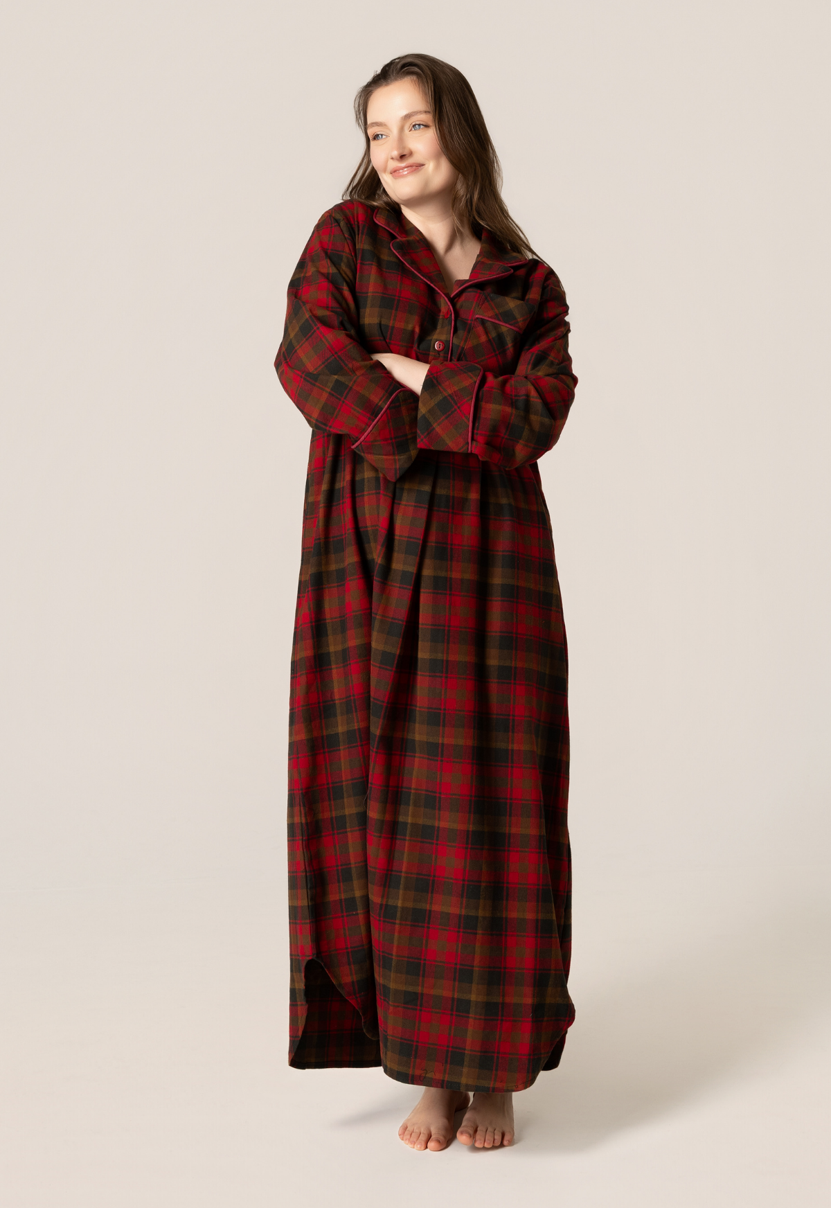 Woman wearing a long maple leaf tartan nightshirt on a beige background