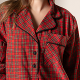 Red plaid nightgown worn by a person with a neutral background