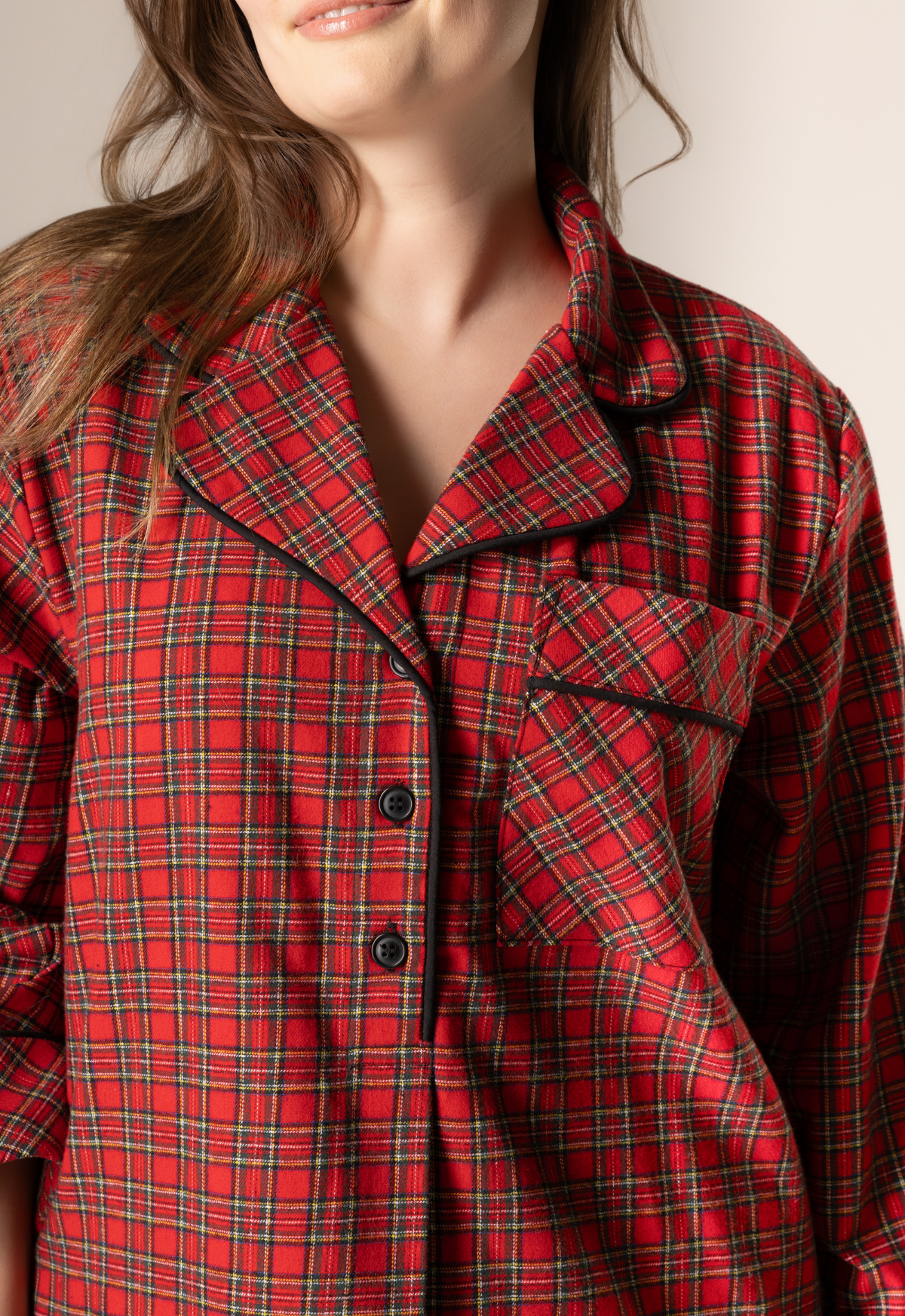 Red plaid nightgown worn by a person with a neutral background