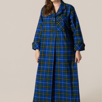 Woman wearing a blue plaid nightshirt on a beige background