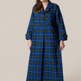 Woman wearing a blue plaid nightshirt on a beige background
