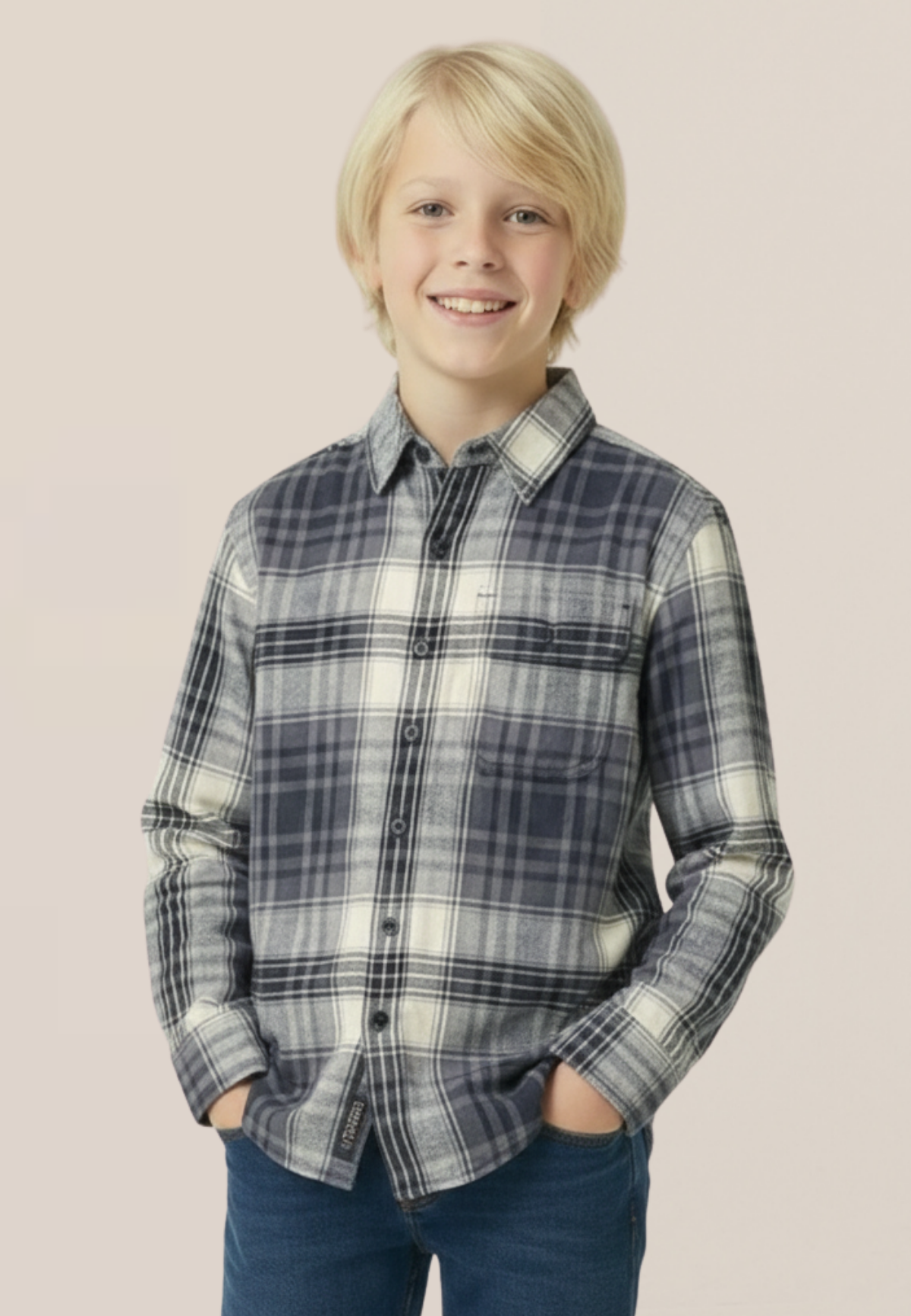 Young boy wearing a plaid shirt against a plain background
