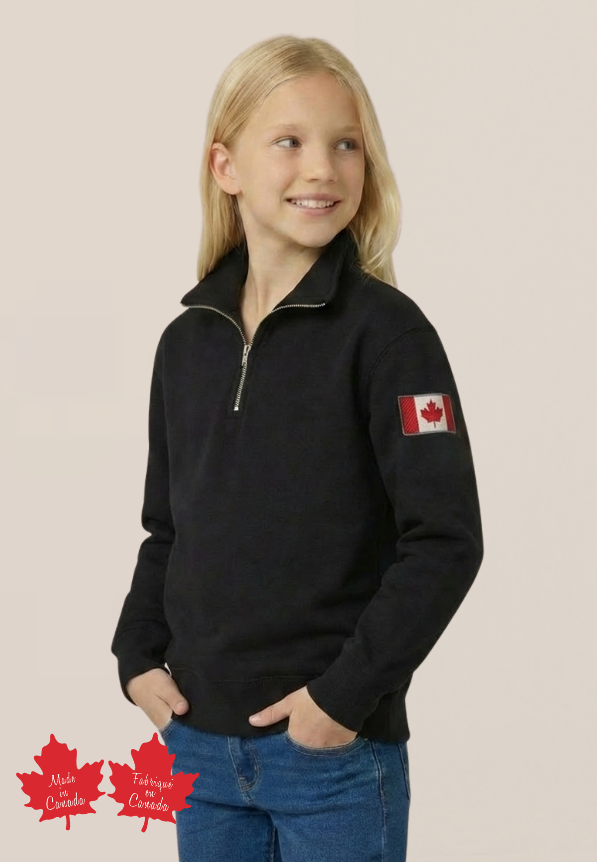 Young girl wearing a black pullover with a Canadian flag patch on a beige background