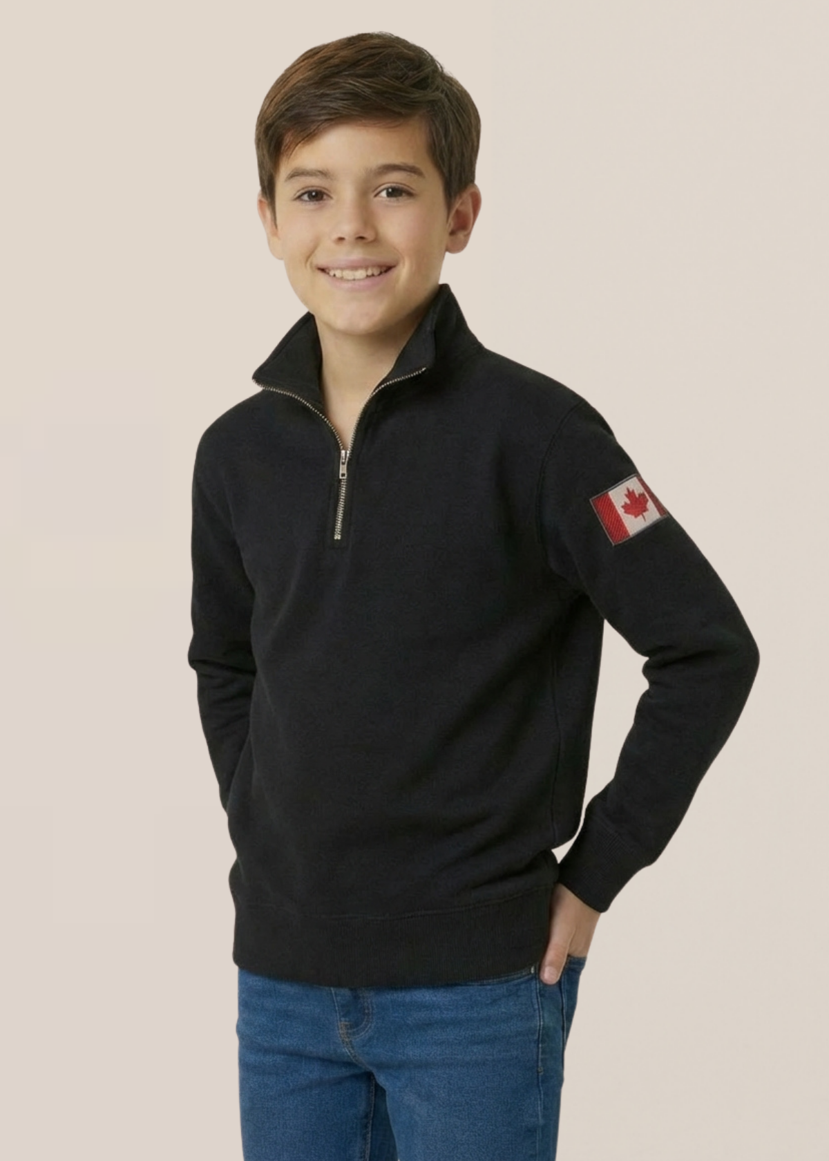Child wearing a black polo with a Canadian flag on a beige background