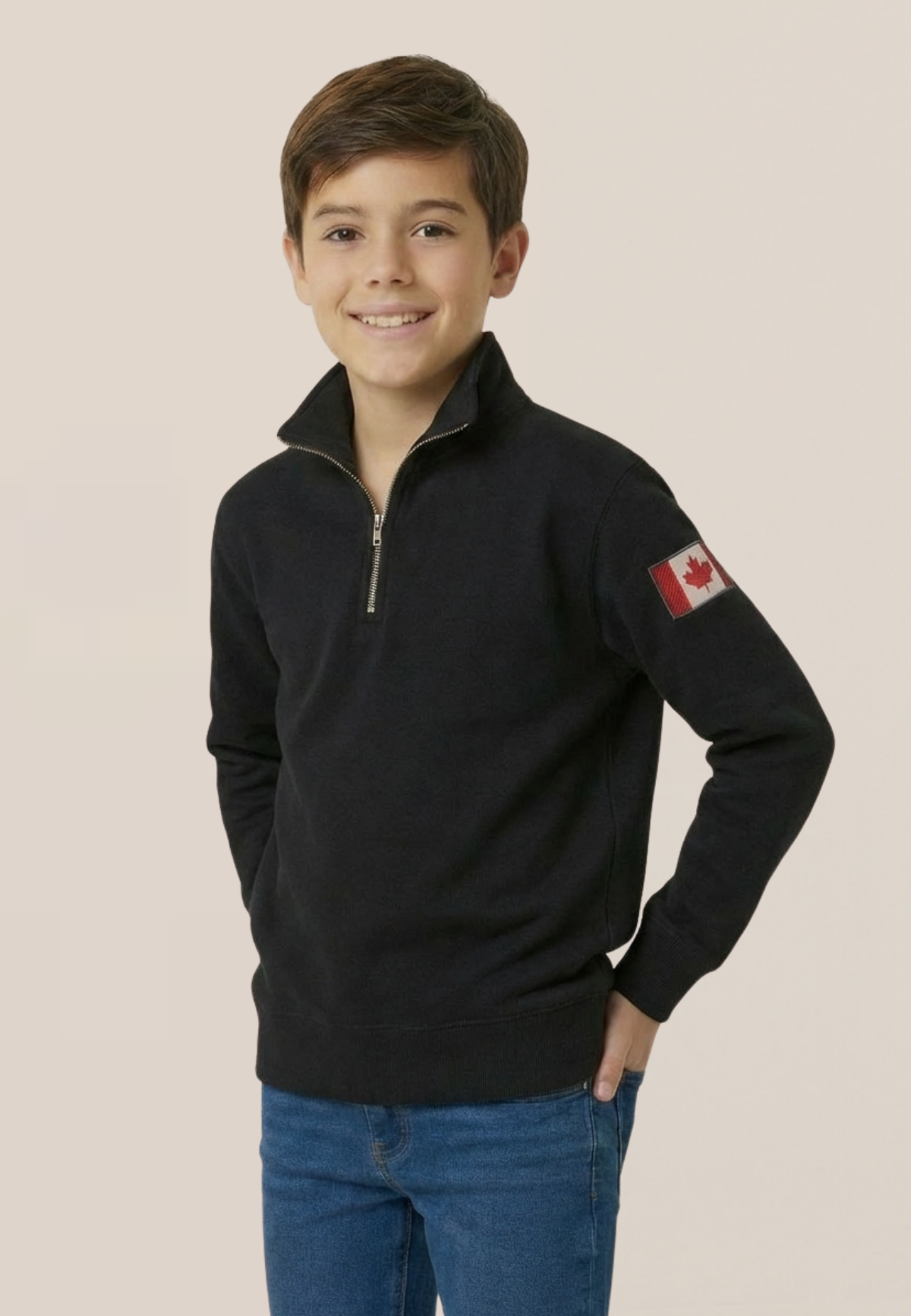 Child wearing a black polo with a Canadian flag on a beige background