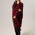 Woman wearing a red and black checkered blanket over her shoulders with 'Made in Canada' logos at the bottom.