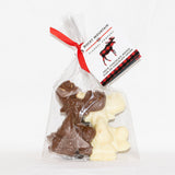 Packaged assorted chocolate treats shaped like moose and other shapes, tied with a red ribbon.
